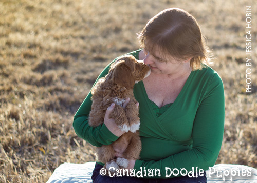The breeder cuddling one of her furry kids
